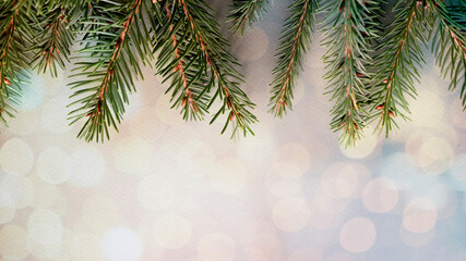 Holiday background. Christmas tree garland on a bokeh background. Spruce branches. The concept of the Christmas and holiday season.
