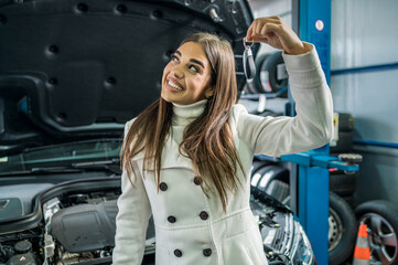 A female client giving keys to car mechanic in the garage