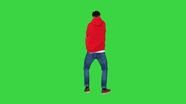 Young man dancing hip-hop doing waves on a Green Screen, Chroma Key.