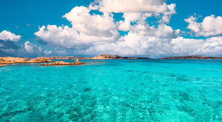 Really stunning turquoise sea water with a wonderful blue and cloudy sky.