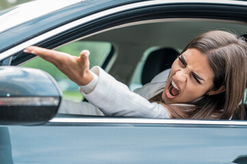 Angry female driving car in the traffic jam 