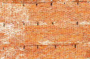 Red cracked brick wall as background texture