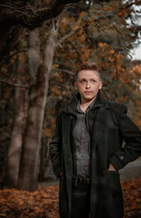 Fototapeta na wymiar young man in the autumn forest