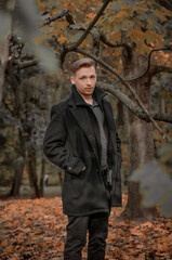 Fototapeta na wymiar young man in the autumn forest