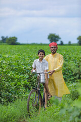 Indian farmer or labor with his child at cotton field