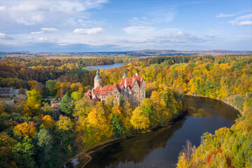 Aerial view of Czocha Castle surrounded by autumn forest and Lesnianskie Lake