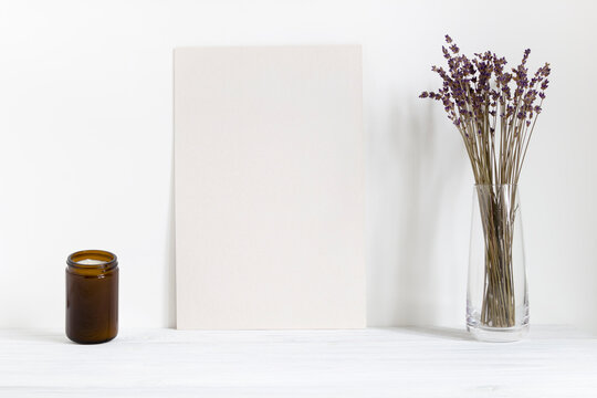 Home interior poster mockup, candle and lavender in vase on table