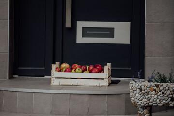 Charity donation box made of wooden crate with fruits, herbs, apples, pears and pomegranate. Pandemic outbreak.