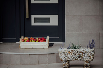 Charity donation box made of wooden crate with fruits, herbs, apples, pears and pomegranate. Pandemic outbreak.