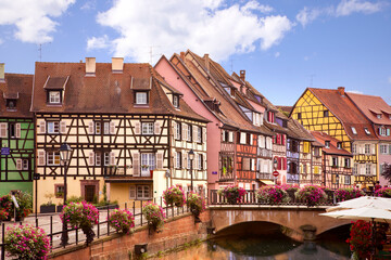Picturesque view on Colmar street. Half-timbered houses, Colourful architecture, canal and blue sky. Travel destination. Alsace, France