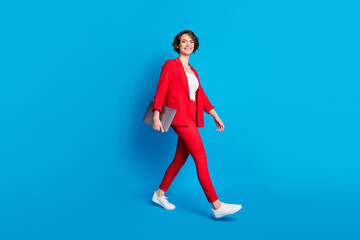 Fototapeta na wymiar Full length body size view of attractive cheerful businesslady specialist going carrying laptop isolated over bright blue color background