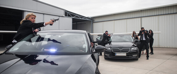 Famous female celebrity with bodyguards surrounded. VIP security agents and close protection...