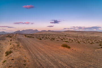 dirt road to the deseret hills at sunset