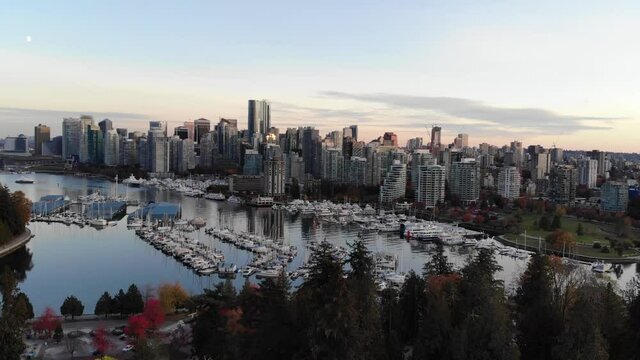 rising aerial crane shot reveal of vancouver downtown and colorful autumn trees
