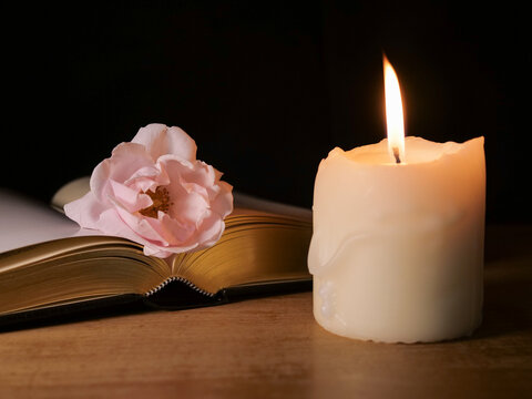 Bible book, candle and rose, symbolic for funeral