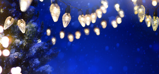 Christmas Tree light over Snowy dark blue sky background