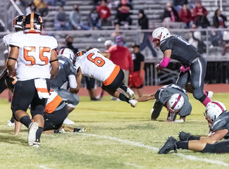 Football players displaying amazing athletic ability while making plays during a game