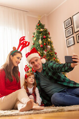 Family taking selfie while celebrating Christmas