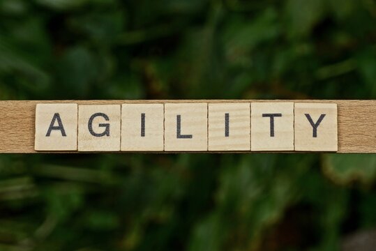 Gray Word Agility Made Of Wooden Square Letters On Green Background