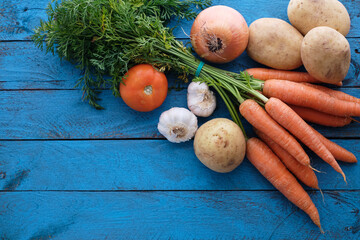 Vegetables and legumes on blue wooden table