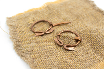 Isolated photos of a medieval copper fibula