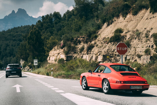 Red Colour Porsche 911 Carrera 2 Coupe In Motion On Spanish Motorway Highway Freeway Road.