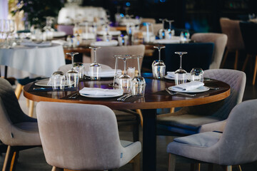 tableware Glasses, flower fork, knife served for dinner in restaurant with cozy interior