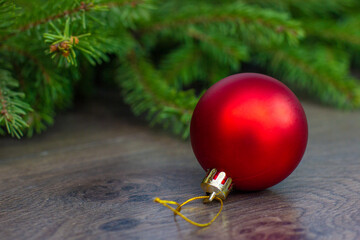 a Christmas tree toy in the form of a red ball hangs on the floor waiting for the Christmas tree to be decorated