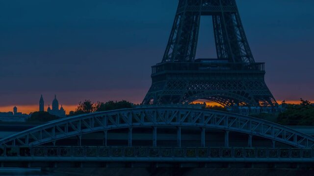 Eiffel Tower sunrise timelapse with boats on Seine river and in Paris, France. View from Grenelle bridge. Close up view