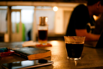 glass of coffee on cafe table at night