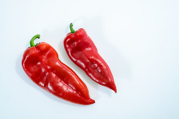 Two red peppers on white background