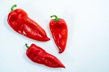 Three red peppers on white background
