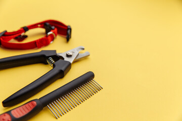 Pet care concept. Tools for grooming on yellow background