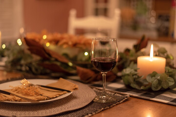 Holiday table setting by candlelight - celebrating at home