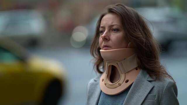 portrait of middle-aged woman with neck brace in city, closeup, curing and prevention of osteochondrosis, neck pain and cronic headache