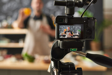 Food blogger shooting his blog about cooking recipes on professional camera