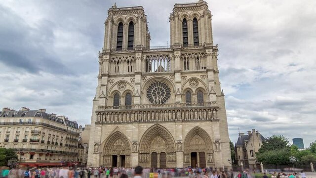 Front view of Notre-Dame de Paris timelapse hyperlapse is a medieval Catholic cathedral on the Cite Island in Paris, France. Long queue of tourists. Cloudy sky at summer day