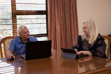 Portrait of senior woman and man work on laptop.
