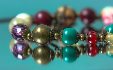 Colorful necklace beads are reflected in the mirror