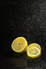 lemon on black in water