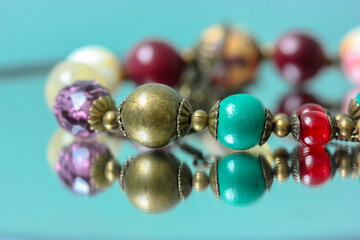 Colorful necklace beads are reflected in the mirror