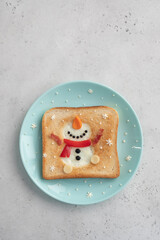 Christmas breakfast: toast with egg white in the shape of happy snowman