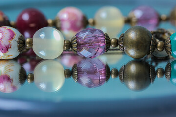 Colorful necklace beads are reflected in the mirror