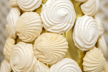 White marshmallow in the shape of a shell. Sweet high-calorie dessert.