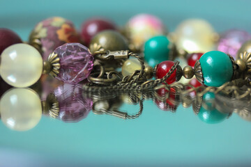 Colorful necklace beads are reflected in the mirror