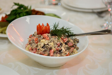 Mixed salad of vegetables and meat. Festive cold appetizer on the table.