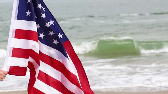 American Flag blowing in the wind on sea background. USA American Flag. Memorial Day - American concept.