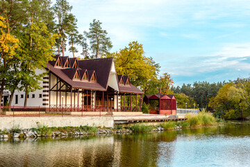 A small complex hotel in the forest consisting of several houses in pines on the banks of the river.