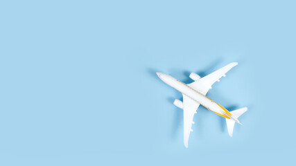 Naklejka na ściany i meble model of passenger airplane on blue background. Flat lay travel concept design. Copy space