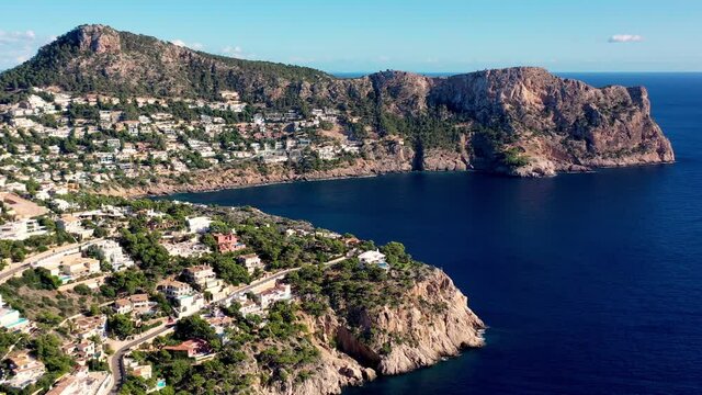 LLamp Cape near Port Andratx in Mallorca Spain with seaside homes on the cliffs, Aerial dolly right reveal shot
